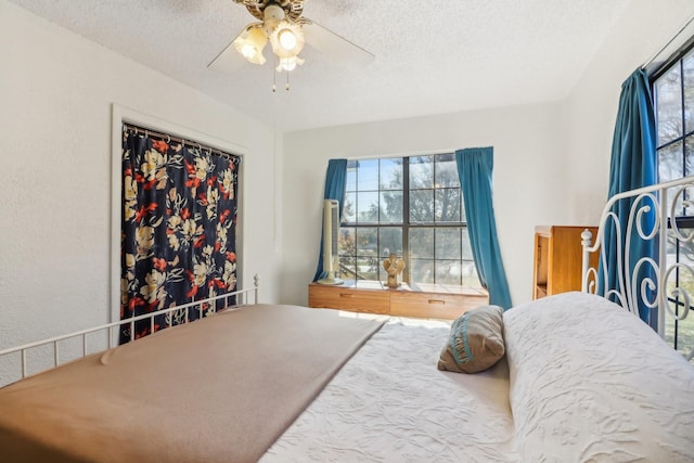 bedroom featuring ceiling fan, a closet, and a textured ceiling