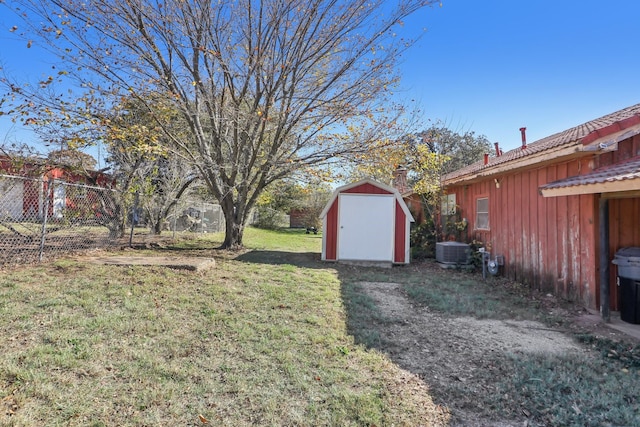 view of yard with cooling unit and a storage shed