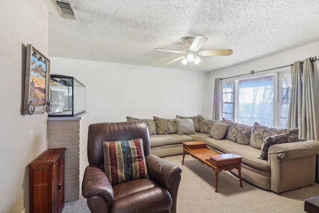 living room featuring a textured ceiling, light colored carpet, and ceiling fan