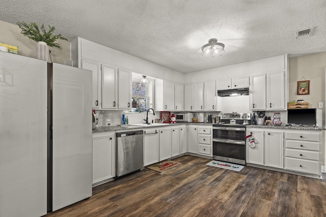 kitchen featuring white cabinetry, sink, stainless steel appliances, and dark hardwood / wood-style floors