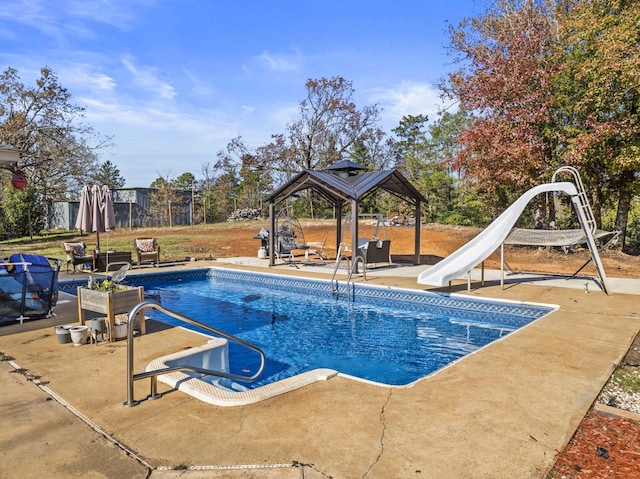 view of pool with a gazebo, a water slide, and a patio