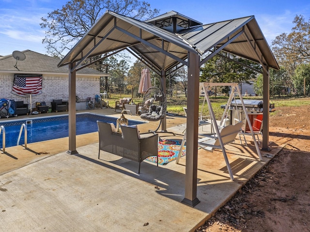 view of swimming pool featuring a gazebo, a patio, and a playground