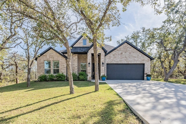 view of front of property featuring a front lawn and a garage