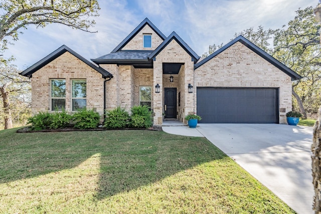 view of front of house with a front lawn and a garage