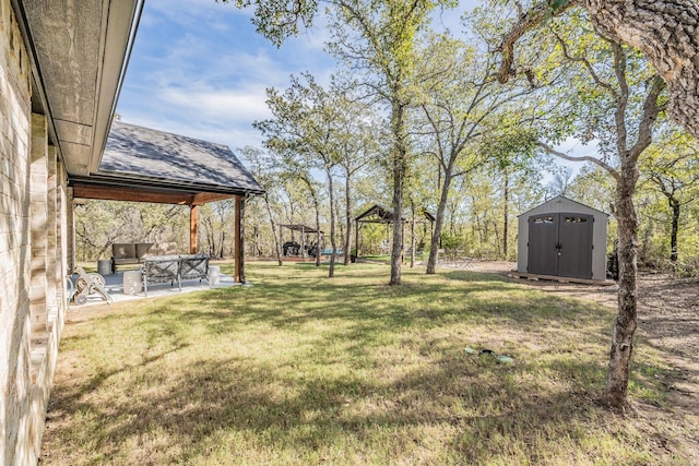 view of yard featuring a gazebo, outdoor lounge area, a patio, and a storage unit