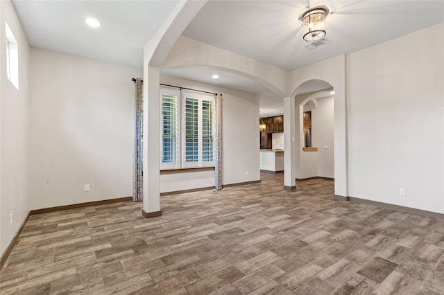 unfurnished living room featuring hardwood / wood-style flooring and plenty of natural light