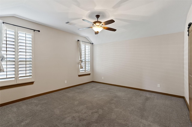 unfurnished room featuring ceiling fan, carpet floors, and vaulted ceiling