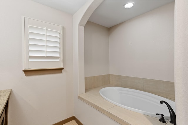 bathroom featuring tiled tub