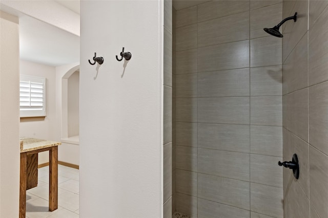 bathroom featuring tiled shower and tile patterned floors