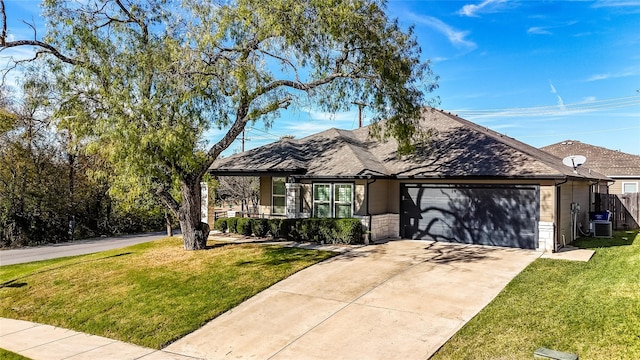 view of front of property with central AC unit, a garage, and a front lawn