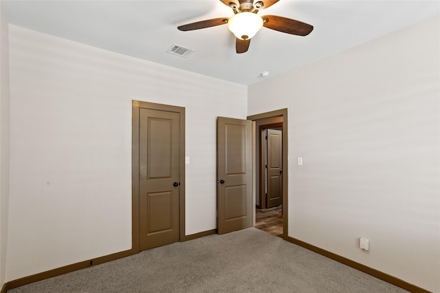 unfurnished bedroom with ceiling fan and carpet floors