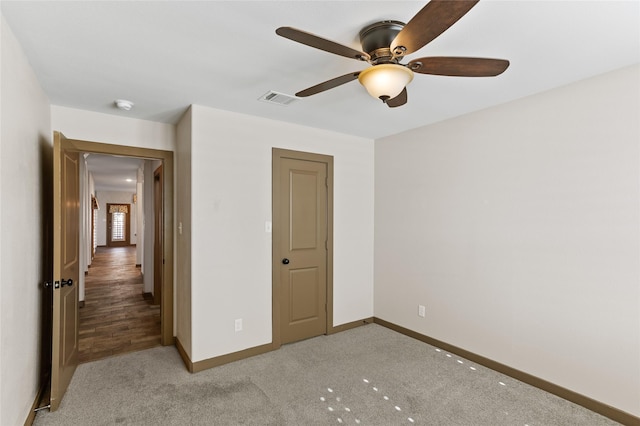 unfurnished bedroom featuring ceiling fan and carpet flooring