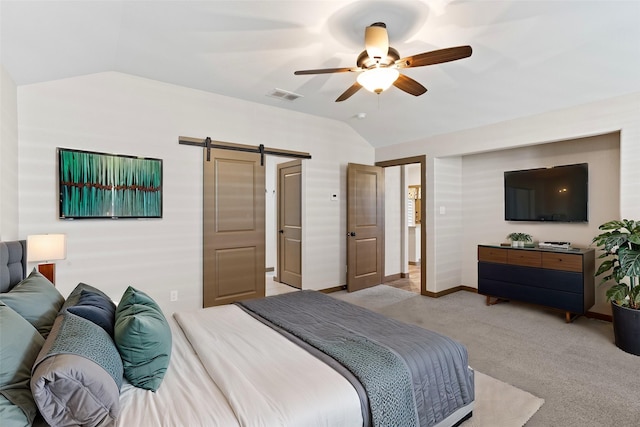 carpeted bedroom featuring lofted ceiling, a barn door, and ceiling fan