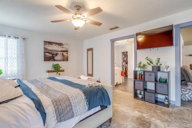 bedroom featuring ensuite bath, ceiling fan, and a textured ceiling