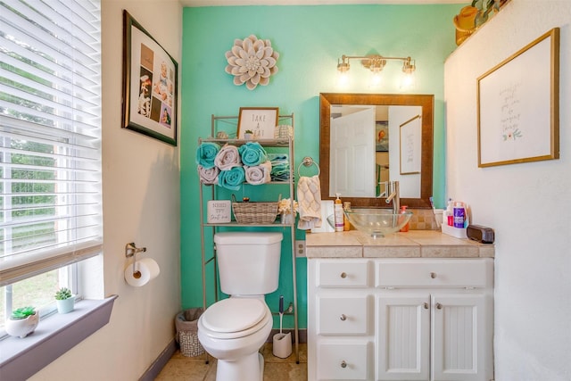 bathroom featuring toilet, vanity, and tile patterned floors