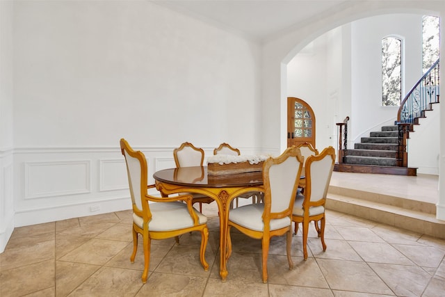 tiled dining space featuring ornamental molding