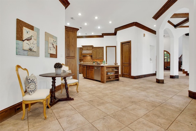 interior space with light tile patterned floors and crown molding