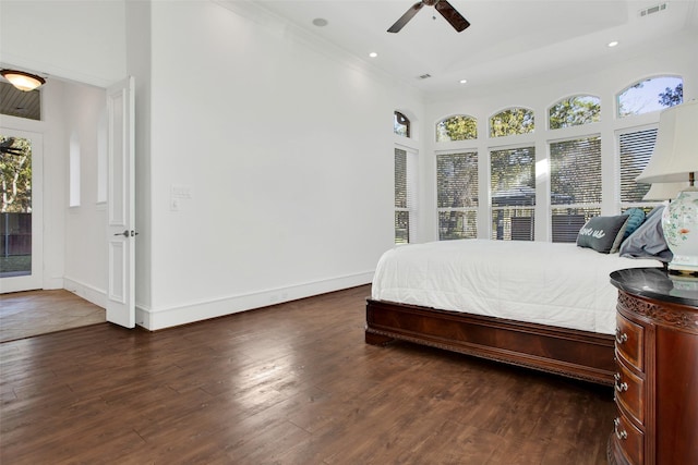 bedroom with access to outside, dark hardwood / wood-style floors, multiple windows, and ceiling fan