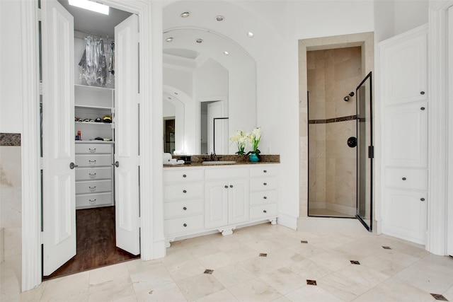 bathroom featuring vanity, wood-type flooring, and walk in shower