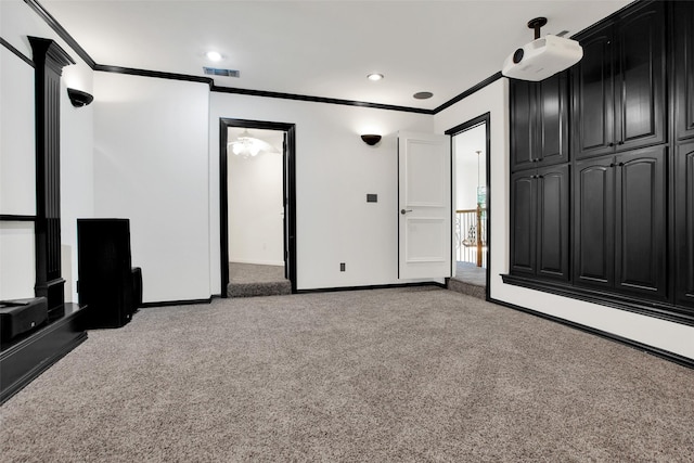 interior space with ceiling fan, carpet floors, and ornamental molding