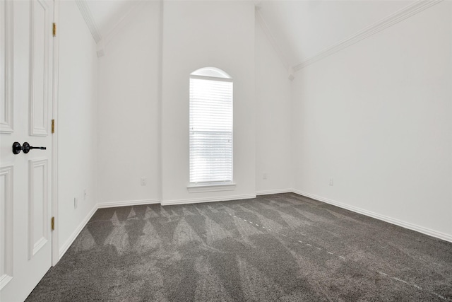 carpeted empty room with crown molding and vaulted ceiling