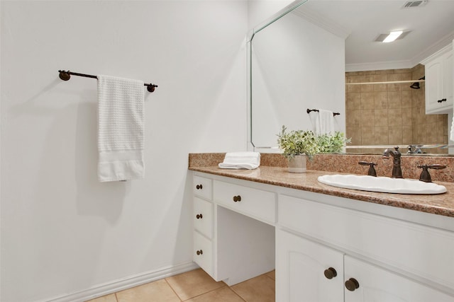 bathroom featuring tile patterned floors, crown molding, and vanity