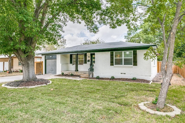 ranch-style house with covered porch, a garage, and a front lawn