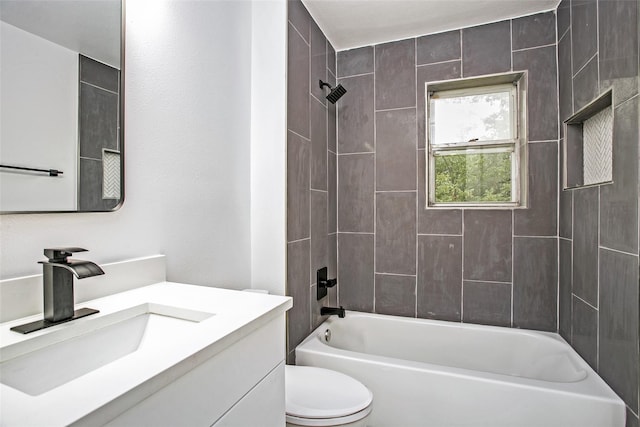 full bathroom featuring toilet, vanity, and tiled shower / bath combo