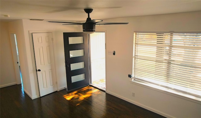 entryway featuring ceiling fan, dark wood-type flooring, and a healthy amount of sunlight