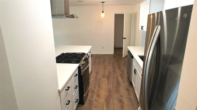 kitchen with hanging light fixtures, dark hardwood / wood-style flooring, range hood, white cabinets, and appliances with stainless steel finishes