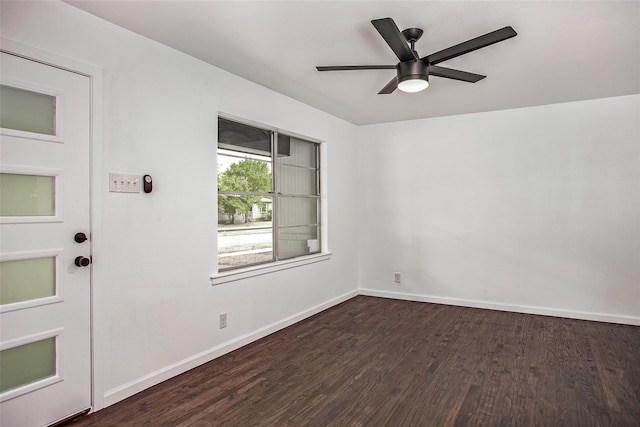 spare room with dark wood-type flooring and ceiling fan