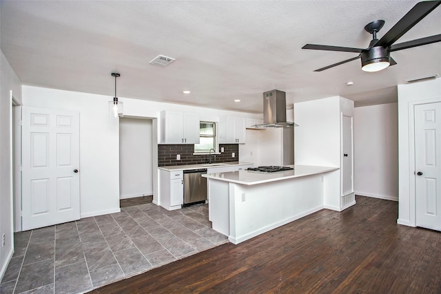 kitchen with white cabinetry, dark wood-type flooring, range hood, and appliances with stainless steel finishes