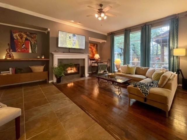 living room featuring crown molding, dark hardwood / wood-style flooring, and ceiling fan