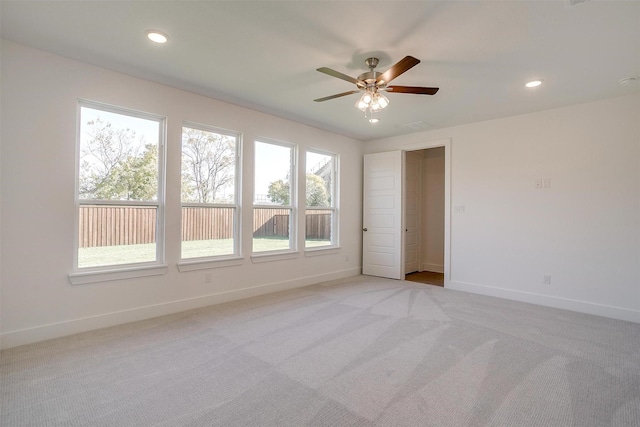 carpeted empty room featuring ceiling fan