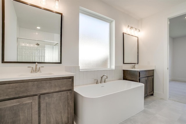 bathroom featuring tile patterned floors, vanity, and separate shower and tub