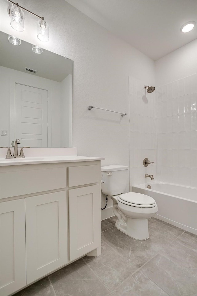 full bathroom with vanity, toilet, and tiled shower / bath