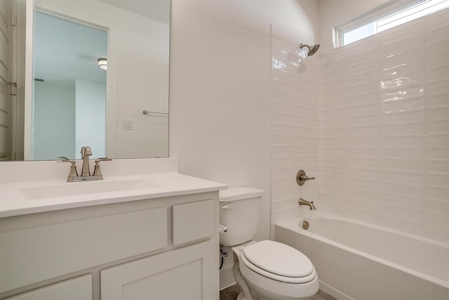 full bathroom featuring tiled shower / bath, vanity, and toilet