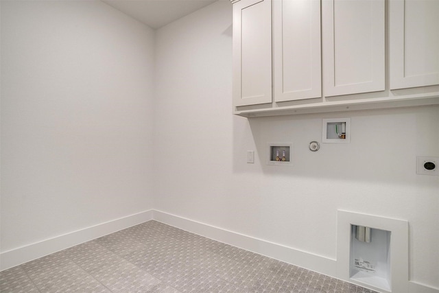 laundry area with electric dryer hookup, washer hookup, hookup for a gas dryer, and cabinets