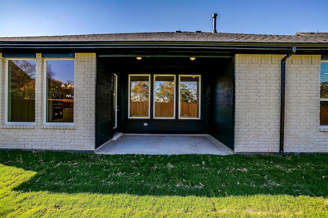 property entrance featuring a yard and a patio