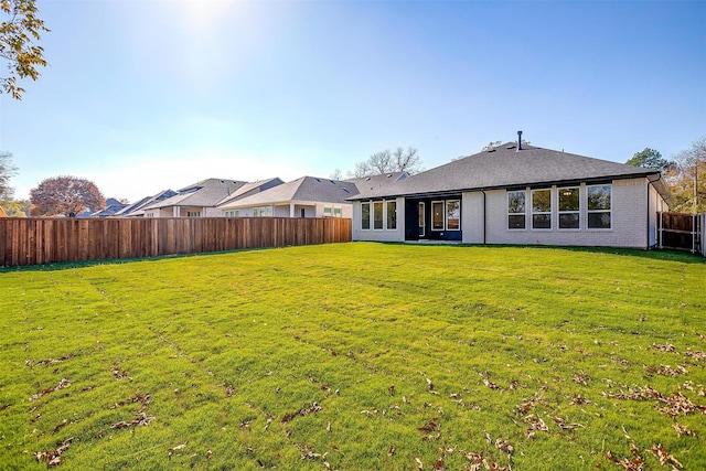 rear view of house with a yard