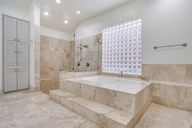 bathroom featuring separate shower and tub and vaulted ceiling