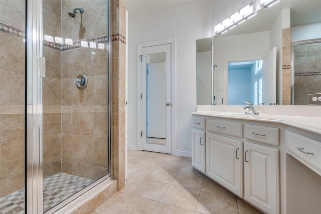 bathroom featuring vanity, tile patterned flooring, and walk in shower