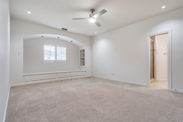 carpeted empty room featuring ceiling fan