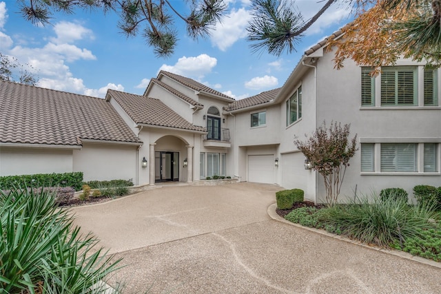 mediterranean / spanish house with a garage