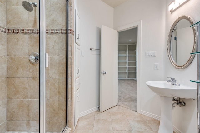 bathroom featuring tile patterned floors, sink, and a shower with door