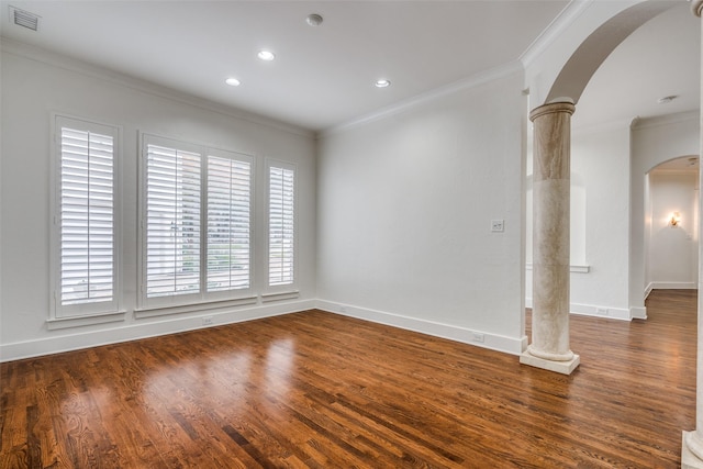 spare room with ornate columns, ornamental molding, and dark hardwood / wood-style flooring