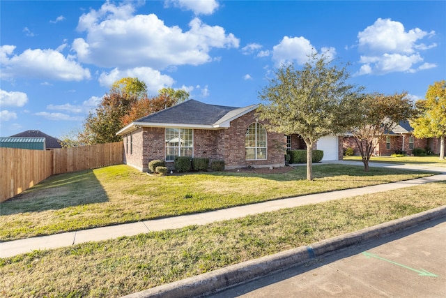 ranch-style house featuring a garage and a front lawn