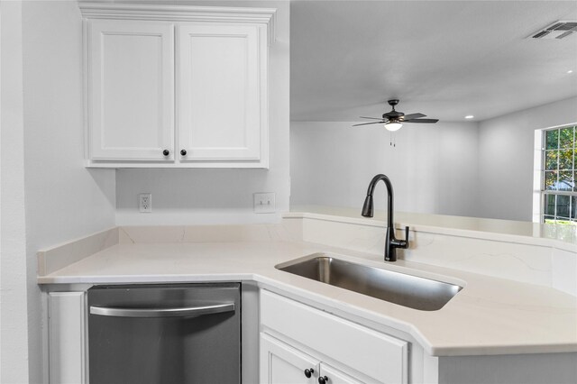 kitchen featuring stainless steel dishwasher, white cabinetry, and sink