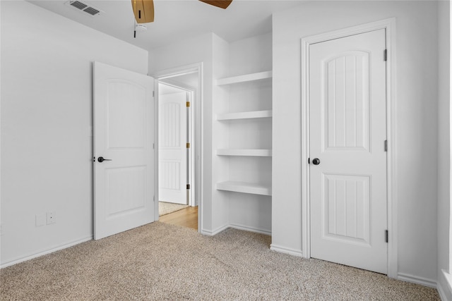 unfurnished bedroom featuring ceiling fan and light colored carpet