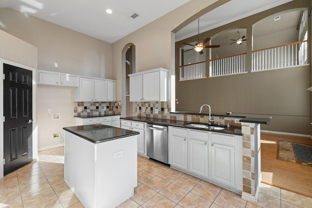 kitchen featuring white cabinetry, dishwasher, sink, ceiling fan, and a kitchen island